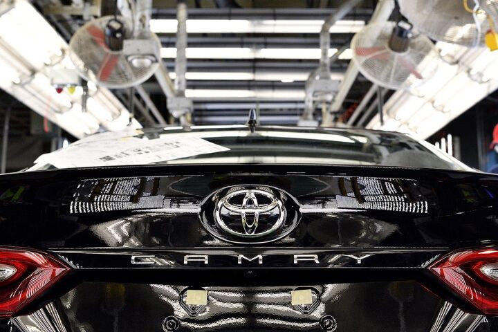 toyota scales back june production ford drops german factory